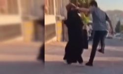 Sokak ortasında eşini darbetti